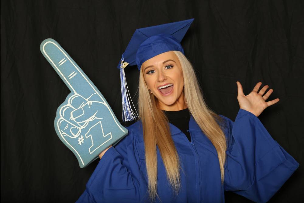 student poses with foam finger